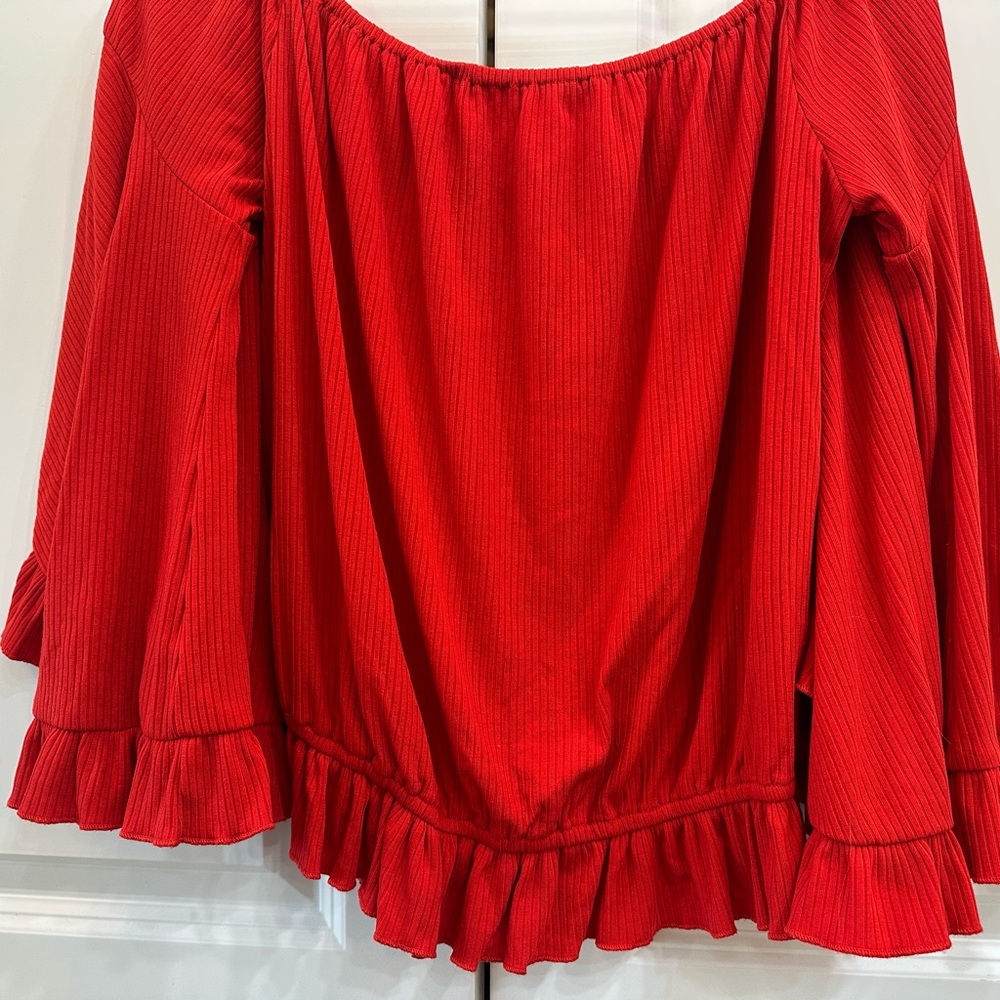 From Buckle: Off the shoulder top with flirty sleeves.